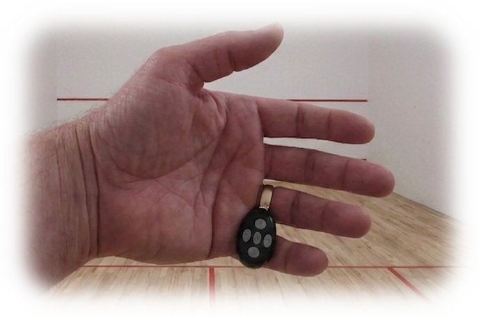 Hand wearing the clicker on a squash court
